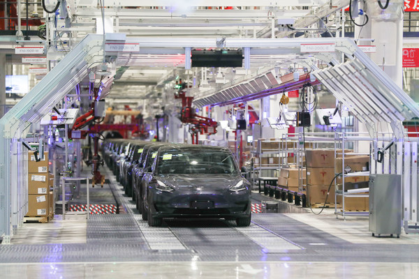 Electric cars roll off the production line at a Tesla plant in Shanghai
