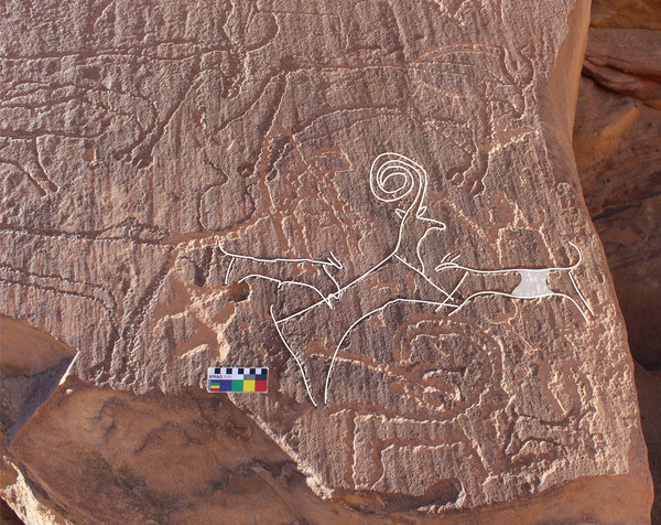 An AlUla rock art panel shows two dogs hunting an ibex, surrounded by cattle. The weathering patterns and superimpositions visible on this panel indicate a late Neolithic age for the engravings, within the date range of the burials at the recently excavated burial sites.