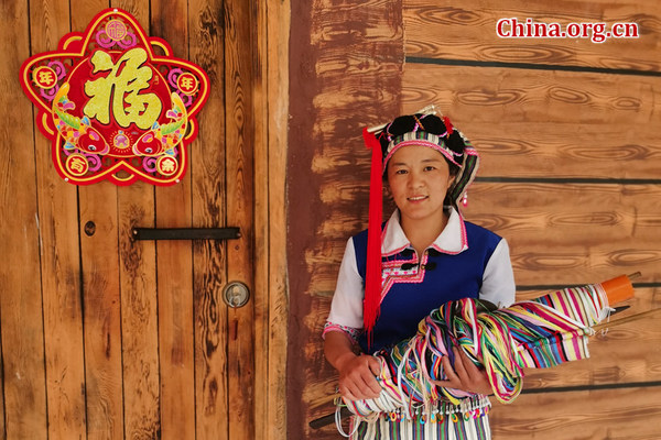 Ma Jinhua in Chala village, Yunnan province, stands beside her family-run homestay inn on May 20, 2021. [Photo by He Shan/China.org.cn]
