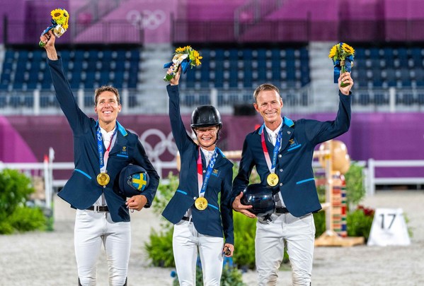 Team Sweden on the podium. (L to R): Henrik von Eckermann, Malin Baryard-Johnsson and Peder Fredricson. Almost a century since Sweden last won Olympic Jumping Team gold and tonight they did it with both style and grace at the Tokyo 2020 Olympic Games in Baji Koen Equestrian Park. (FEI/Arnd Bronkhorst)