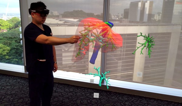 With the help of a Mixed Reality headset, a three-dimensional hologram of a patient’s liver scan is projected into space, allowing Dr Gao Yujia, Associate Consultant with the Division of Hepatobiliary & Pancreatic Surgery, National University Hospital, and the programme lead for the holomedicine programme at the National University Health System to control and view the holographic image from different angles.