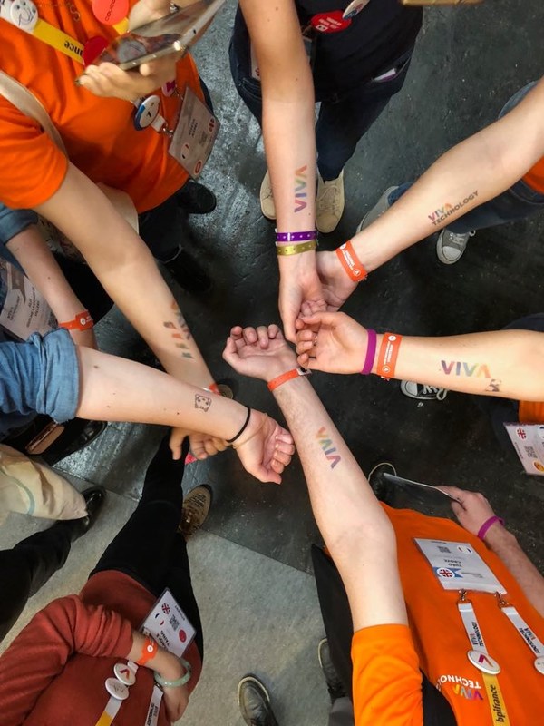 Event attendees show off their new temporary brand logo tattoos