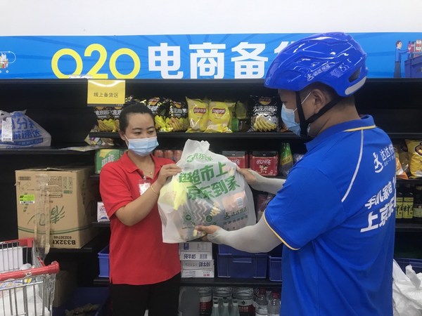 A Dada Now rider takes online orders for delivery at a CP Lotus store in Beijing