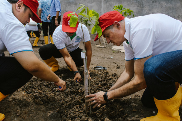 President Director PT Mowilex, Niko Safavi, planting trees at Purwakarta, West Java, Indonesia.