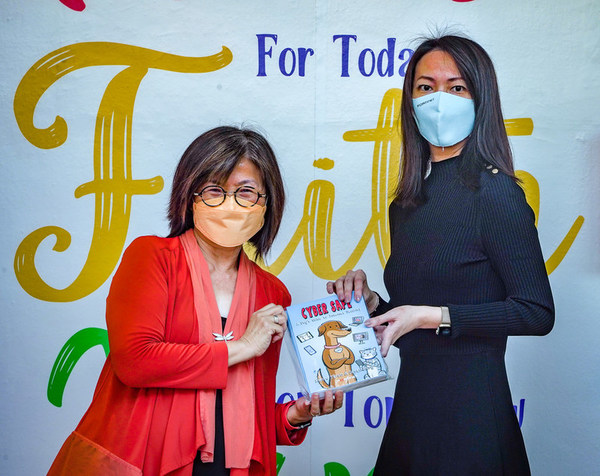 Ms Jess Ng, Country Head for Singapore & Brunei, Fortinet presenting the books to Ms Lisa Choy, Principal at Grace Orchard School