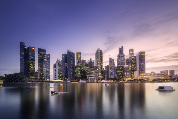 View of downtown district and Marina bay skyline with purple sunrise in Singapore