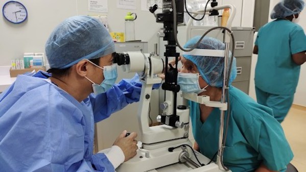 Examining a patient’s eye after the cataract surgery