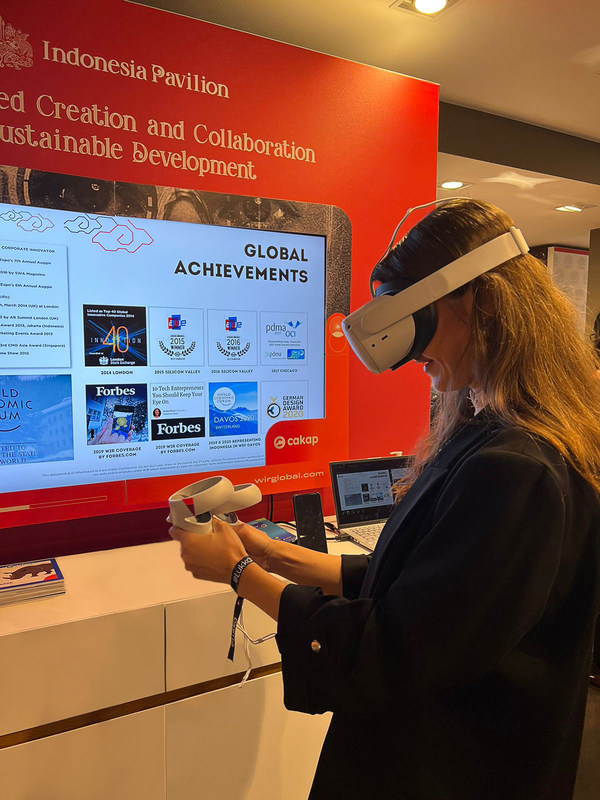 "A visitor to Indonesia Pavilion at the World Economic Forum 2022, Davos, tried out virtual reality technology to interact with the metaverse platform developed by WIR Group"
