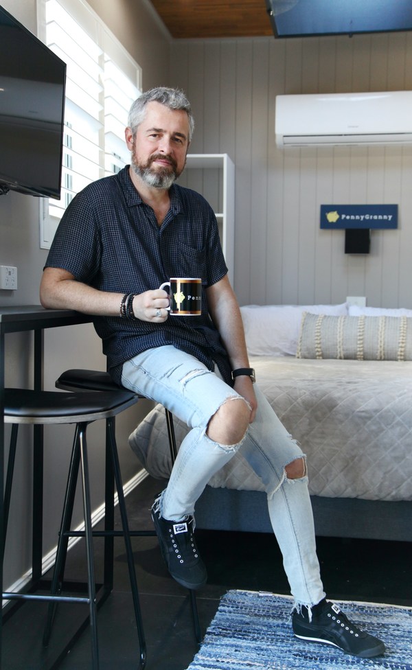Michael Doubinski, CEO of PennyGranny Pty Ltd relaxes inside one of the company's portable homes for hire.