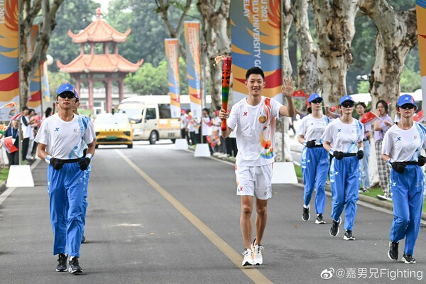 特步体育代言人王嘉男在传递成都大运会火炬