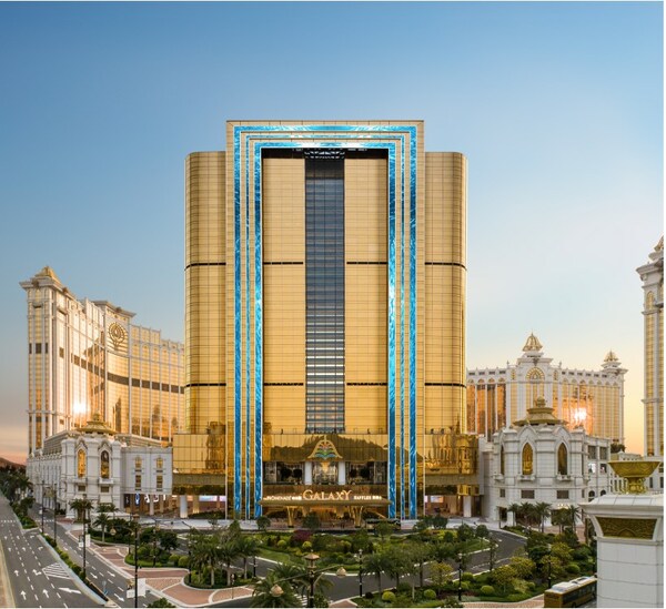 The exterior of Raffles at Galaxy Macau features a pair of enormous LED screens and a glass airbridge that connects the two towers on every floor.