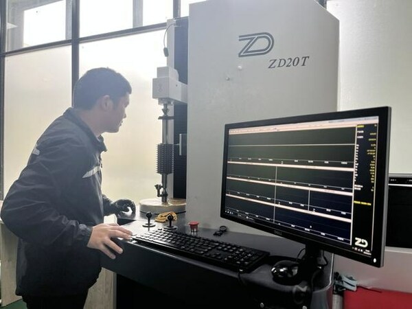 A worker of Guizhou Anxin Numerical Control Technology Co., Ltd. is operating a device.