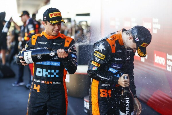 Lando Norris and Oscar Piastri celebrating the McLaren F1 Team's impressive podium streak at the Japanese Grand Prix