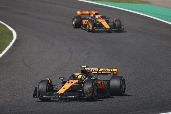 MCL60 race cars in OKX Stealth Mode livery at the Japanese Grand Prix