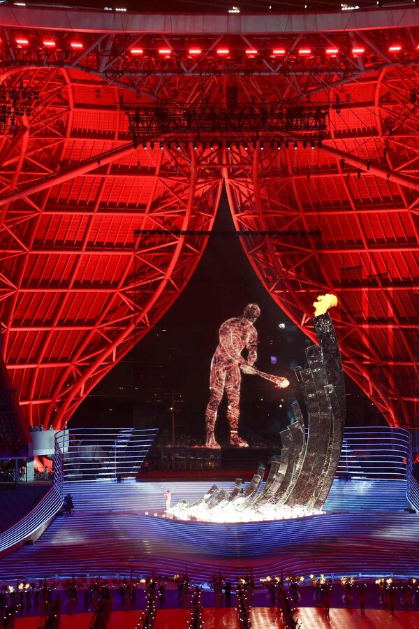 Olympic champion swimmer Wang Shun and a digital torchbearer jointly light the Asian Games cauldron at the opening ceremony of the Hangzhou Asian Games, Sept. 23, 2023. (Photo by Li Yanfei/People's Daily)