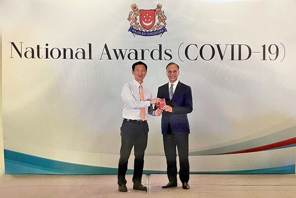 Muhammed Aziz Khan receives the Public Service Medal (COVID-19) from Singapore’s Minister for Health Mr Ong Ye Kung at the National Awards in Singapore Expo.