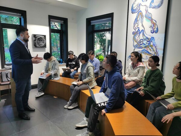 A lecturer passionately teaching a group of attentive students at Tsinghua University.