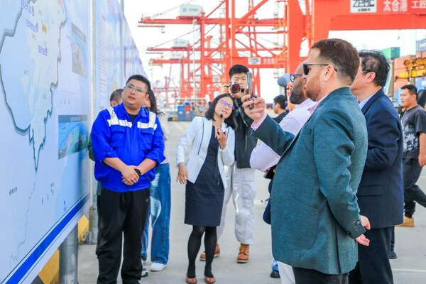 A staff member at Taicang Port in Jiangsu province briefs foreign journalists about the port's operations on Oct 27 during the 2023 Hi Jiangsu Media Trip. The event has been held seven times since its launch in 2015 as a platform to introduce Jiangsu to overseas audiences. [Photo/China Daily]
