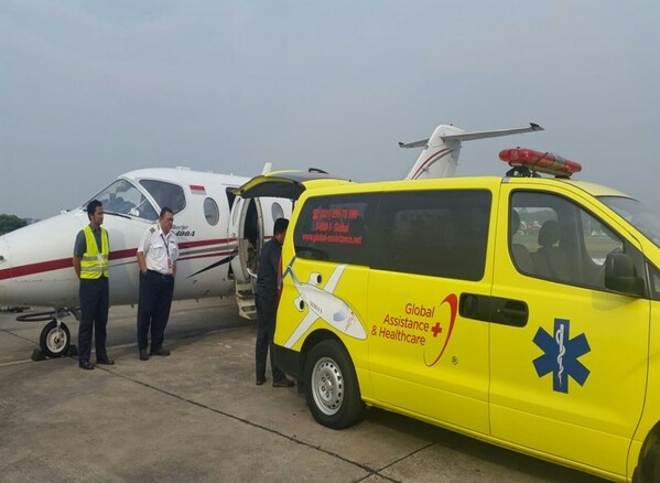 A Global Assistance and Healthcare ambulance together with an aircraft which is used to evacuate patients