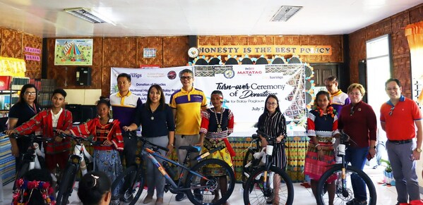 PEDALING TOWARDS LEARNING: (From left to right) DepEd Panabo City Senior Education Program Specialist Ana Liza&  Mendoza, CitySavings Tagum Branch Business Head Rodel Taguiran DepEd Panabo City OIC SDS Jinky Firman, CitySavings Regional Business Head for Southern Mindanao Amor Querido Pavon, DepEd Panabo City ASDS Phoebe Gay Refamonte, CitySavings Davao Branch Business Head Denis Dusong, former Region 11 Assistant Regional Director and currently Caraga Regional Director Maria Ines Asuncion, and DepEd Davao City SDS Reynante Solitario. poses with some of the IP learners of Balay Paglaum during the ceremonial turnover of the bicycles from City Savings Bank.