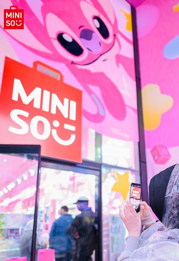 Customer taking photo of MINISO’s Times Square
