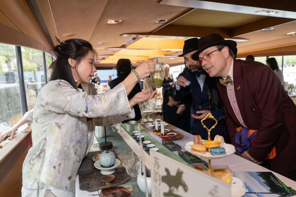 Guests appreciate the Chinese tea performance.