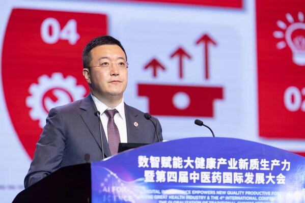Photo taken on May 9, 2024 shows that Yan Kaijing, chairman of Tasly Pharmaceutical Group, is addressing an industrial conference.
