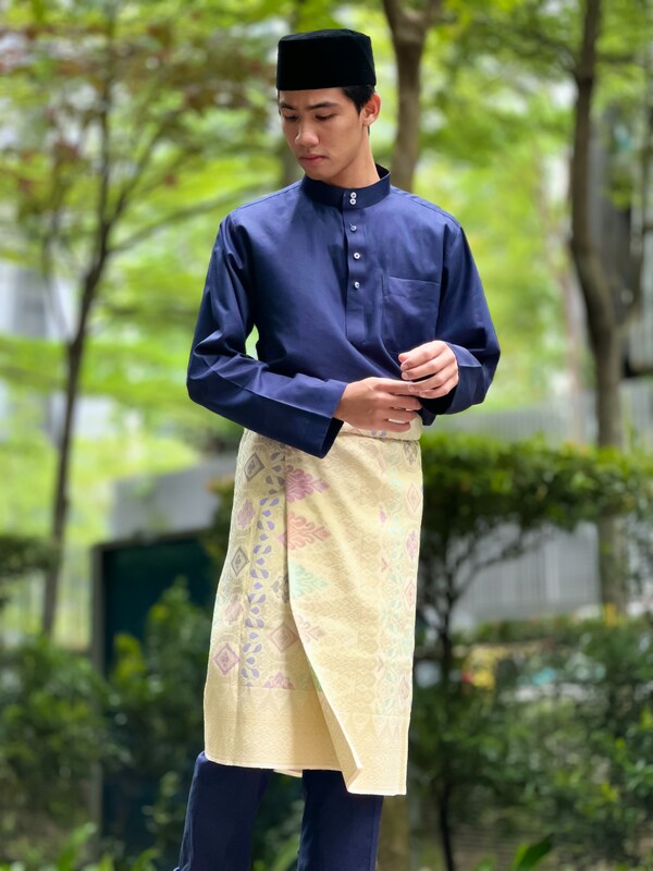 A young man wearing the full Baju Melayu attire by Binwani’s.  Photo by Binwani’s Fashion Group