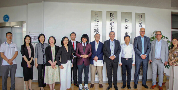 Prof. Dato' Sri Dr Mike Chan stands with delegates from the German Federal Association for Economic Development and Foreign Trade (BWA), City Officials of Baoding, and Sanzang Biotechnology delegates. (PRNewsfoto/EWBG)