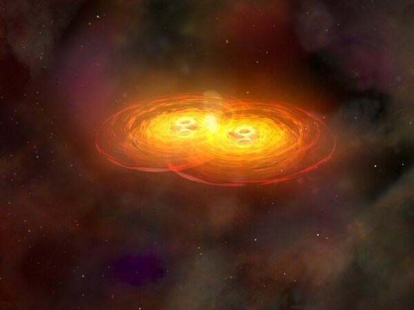 This illustration shows a stage in the merger of two galaxies that forms a single galaxy with two centrally located supermassive black holes surrounded by disks of hot gas. The black holes orbit each other for hundreds of millions of years before they merge to form a single supermassive black hole that sends out intense gravitational waves. Credit: NASA/CXC/A.Hobart, Public domain, via Wikimedia Commons