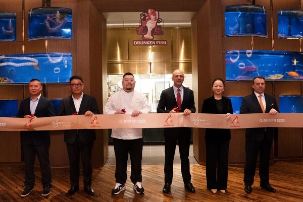 Members of Wynn management and representatives from Trip.com Group and SWH Import & Export Company Limited participate in a ribbon-cutting ceremony to officially open Drunken Fish.