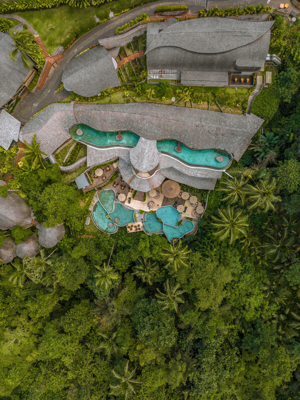 A breathtaking K Club Ubud, revealing its exquisite pool design harmoniously intertwined with lush jungle landscapes, offering guests a refined eco-luxury retreat immersed in the natural beauty of Ubud, Bali.