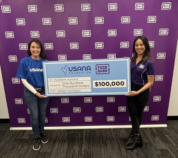 Regional General Manager of USANA Australia and New Zealand Rochelle Potter handing a $100,000 donation check to Foodbank Australia