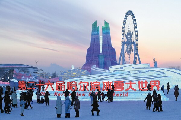 People take photos and explore the 26th Harbin Ice and Snow World. [Photo by Liu Yang]