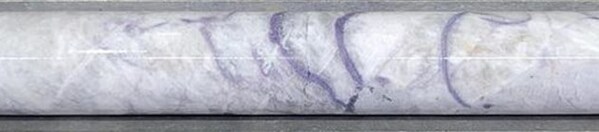 Figure 8: Massive pollucite with lepidolite veining in drill hole CV25-885 at ~240 m depth (core length) at the CV5 Pegmatite’s southwestern extension. Core graded 0.5 m at 17.9% Cs2O over sample interval (240.2 m to 240.7 m). (CNW Group/PMET Resources Inc.) Figure 8: Massive pollucite with lepidolite veining in drill hole CV25-885 at ~240 m depth (core length) at the CV5 Pegmatite’s southwestern extension. Core graded 0.5 m at 17.9% Cs2O over sample interval (240.2 m to 240.7 m). (CNW Group/PMET Resources Inc.)